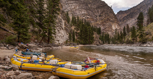 A row of rafts, beached for the night at a camp on the Middle Fork of the Salmon River, Idaho